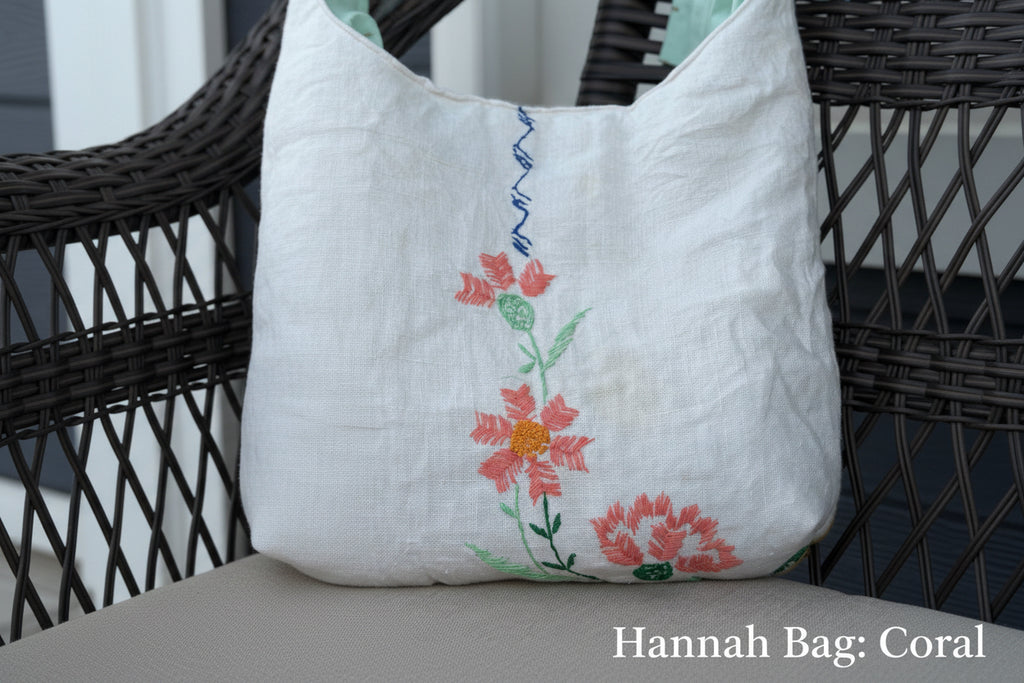 White tote bag with floral embroidery on a chair