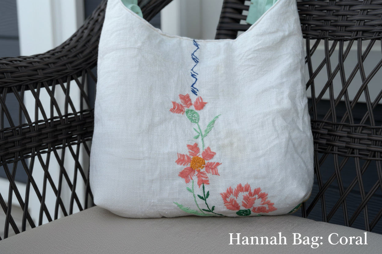 White tote bag with floral embroidery on a chair