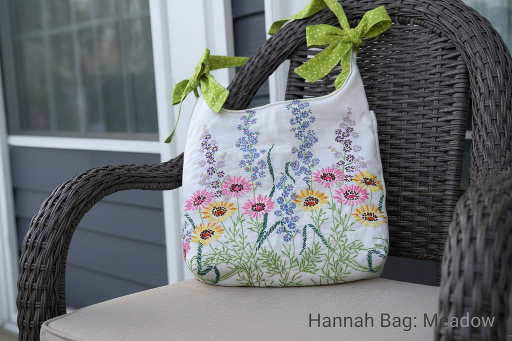 Handbag with floral embroidery and green ribbon on a blurred background