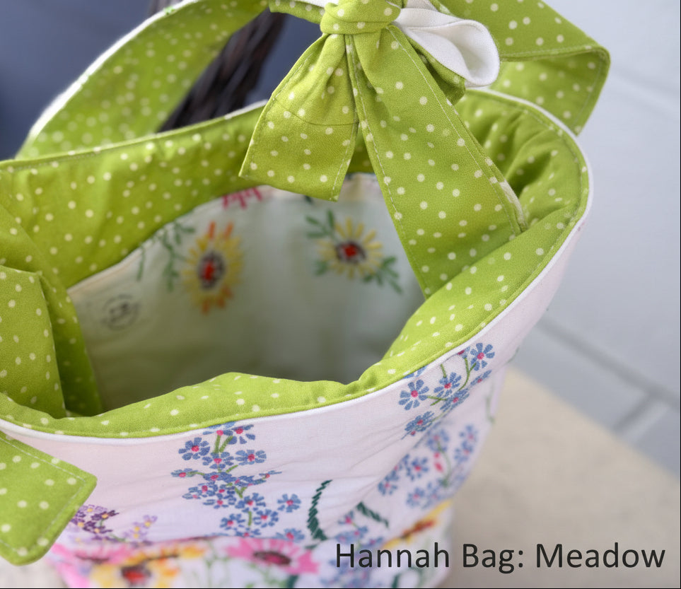 Close-up of a fabric item with green polka dot ribbon and floral patterns.