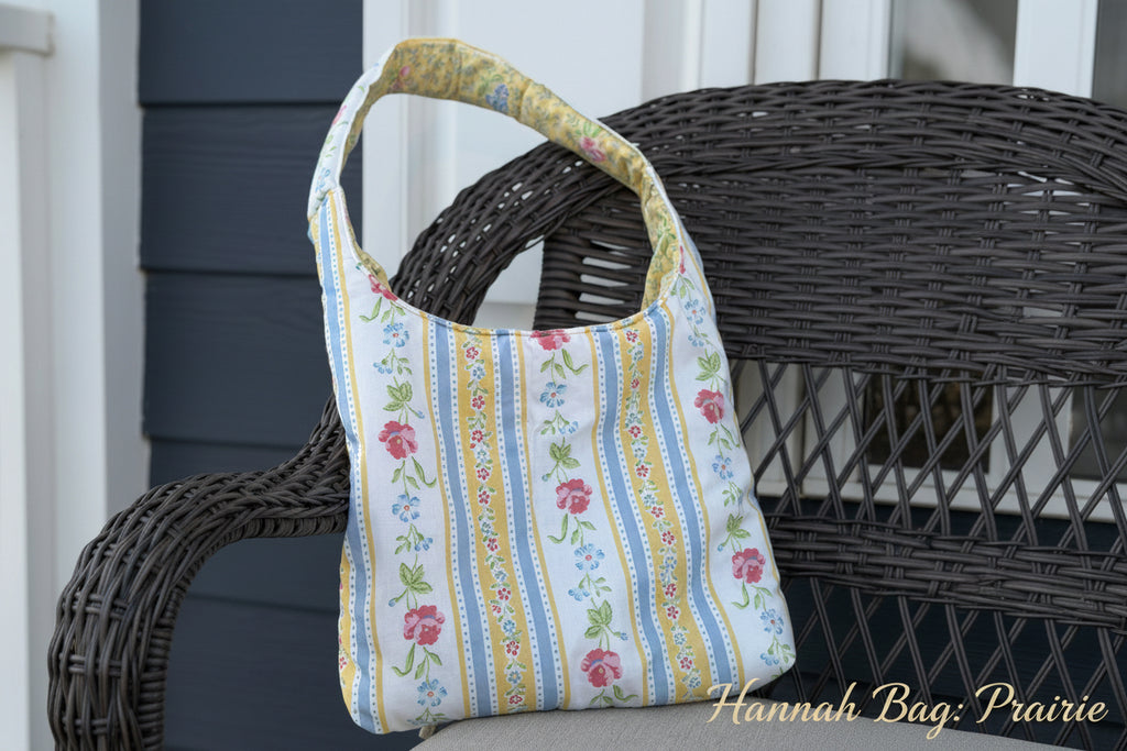 Floral striped bag with a woven chair in the background