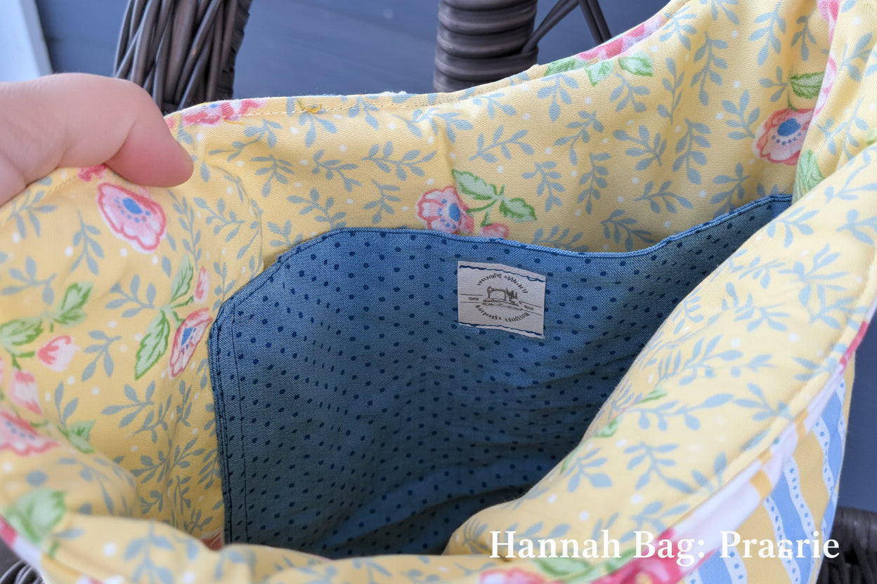 Close-up of a floral-patterned product with a blue interior, possibly a seat or cushion, on a blurred background.